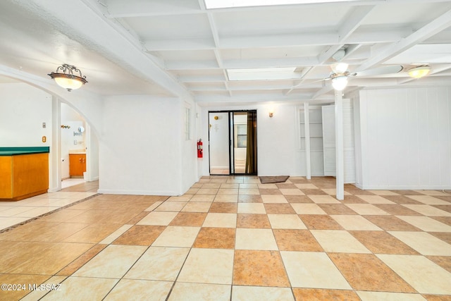 tiled empty room with coffered ceiling