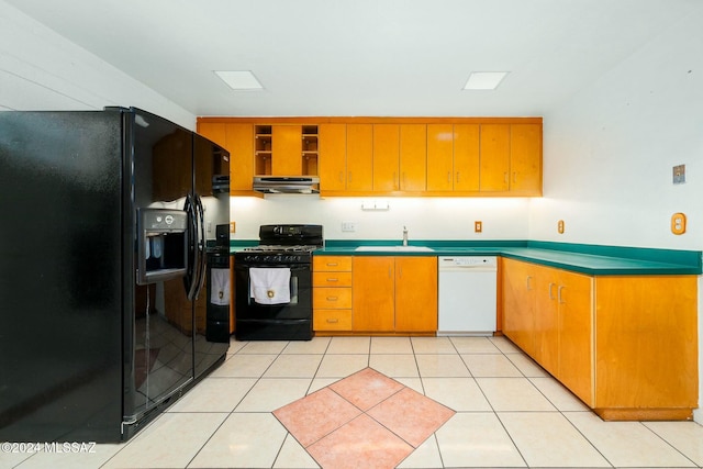 kitchen featuring light tile patterned floors, black appliances, and sink