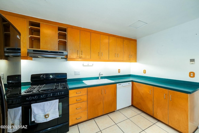 kitchen with black gas range, sink, refrigerator, light tile patterned floors, and white dishwasher