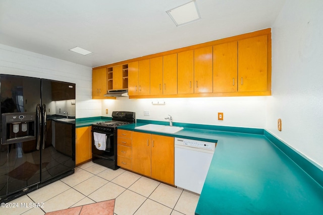 kitchen featuring light tile patterned floors, black appliances, and sink