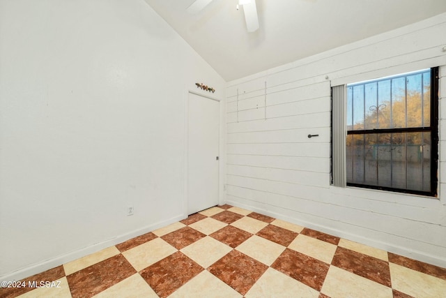 spare room featuring ceiling fan and vaulted ceiling