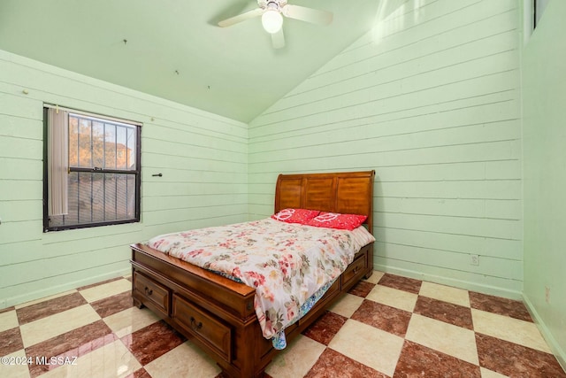 bedroom featuring lofted ceiling, wood walls, and ceiling fan