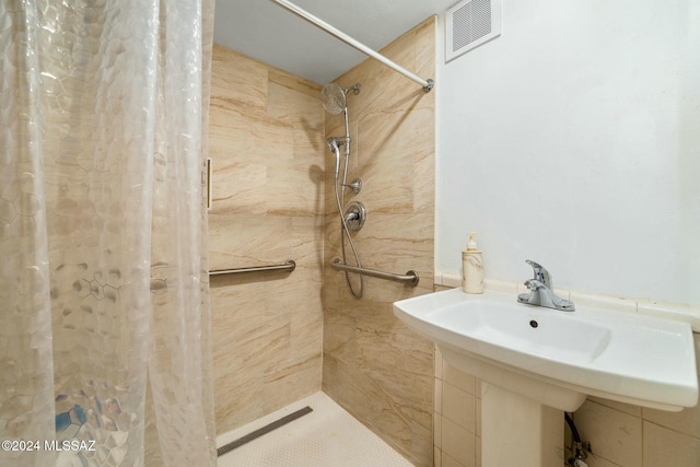 bathroom with sink and a shower with shower curtain