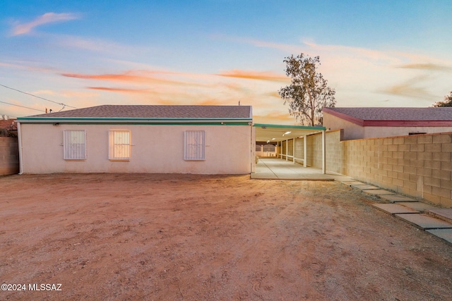 back house at dusk with a patio