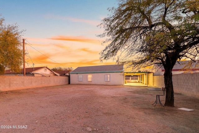 view of back house at dusk