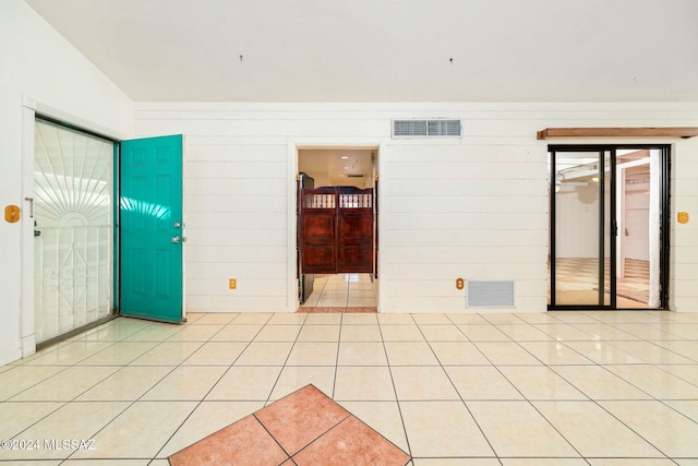 tiled spare room with vaulted ceiling