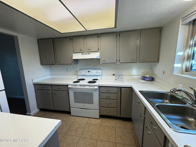 kitchen with sink, gray cabinetry, light tile patterned floors, white electric range oven, and a textured ceiling