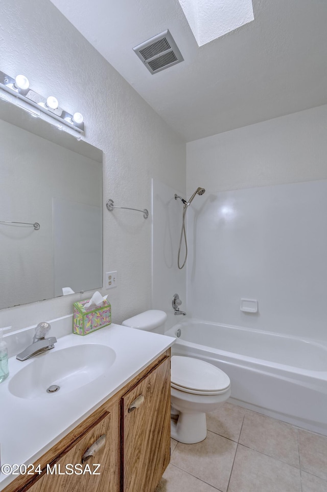 full bathroom with tile patterned floors, toilet, a skylight, vanity, and shower / bath combination