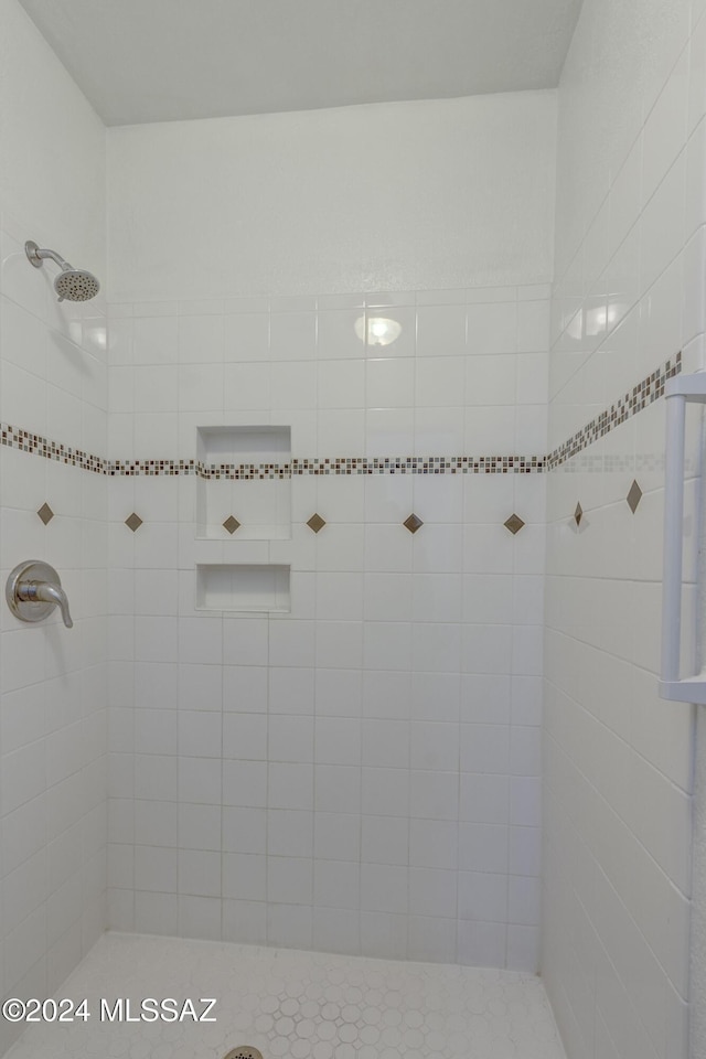 bathroom with a tile shower