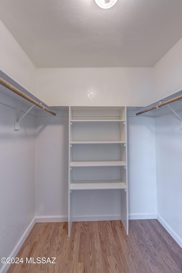 walk in closet featuring hardwood / wood-style floors