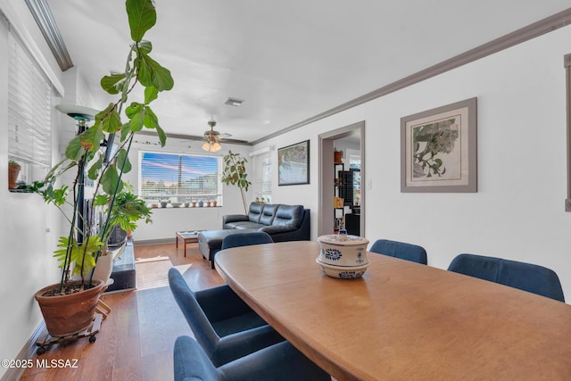 dining space featuring hardwood / wood-style floors, ceiling fan, and ornamental molding