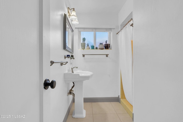 bathroom with walk in shower and tile patterned flooring