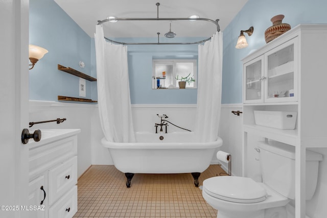 bathroom featuring tile patterned floors, a washtub, and toilet