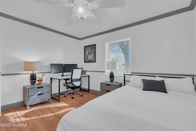 bedroom featuring crown molding, ceiling fan, and light hardwood / wood-style flooring