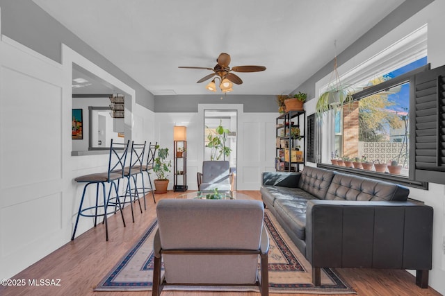 living room featuring ceiling fan and wood-type flooring