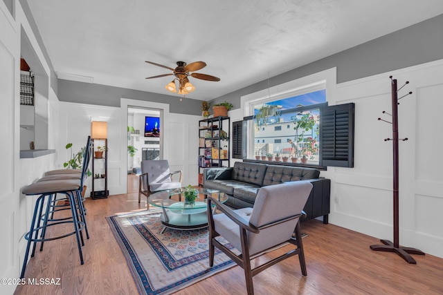 living room featuring hardwood / wood-style floors and ceiling fan