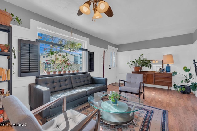 living room featuring ceiling fan and hardwood / wood-style floors