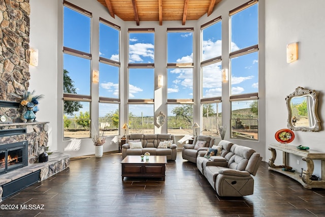 living room with a fireplace, high vaulted ceiling, beamed ceiling, and wood ceiling