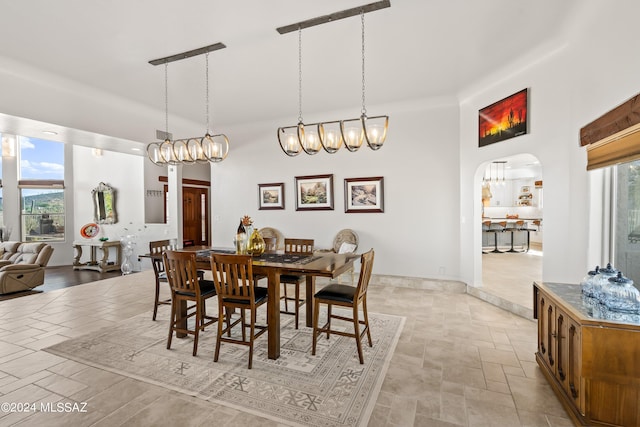 dining room with a high ceiling and a wealth of natural light