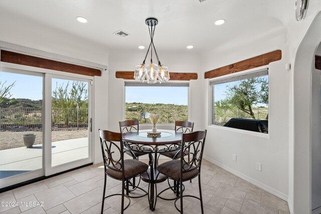 dining space featuring a notable chandelier and a wealth of natural light