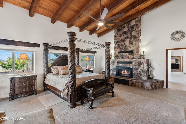 bedroom with a fireplace, ceiling fan, high vaulted ceiling, wooden ceiling, and beamed ceiling