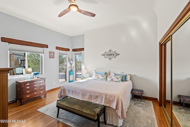 bedroom with ceiling fan, light hardwood / wood-style floors, access to outside, and a closet