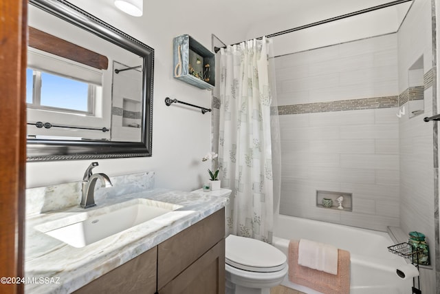 full bathroom with shower / tub combo with curtain, vanity, and toilet