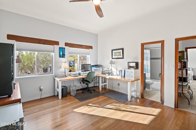 office space featuring ceiling fan and light hardwood / wood-style flooring