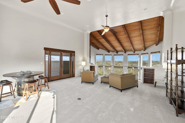 carpeted living room featuring beam ceiling, wooden ceiling, high vaulted ceiling, and french doors