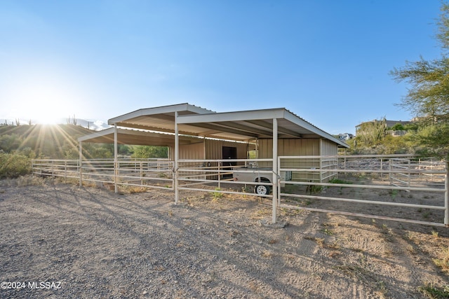 view of stable with a rural view