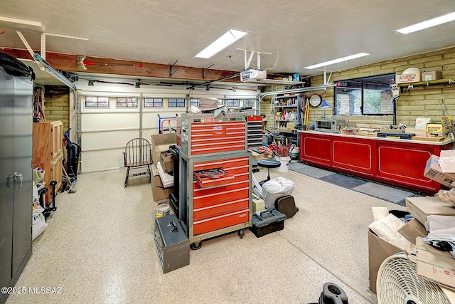 garage with a workshop area and a garage door opener