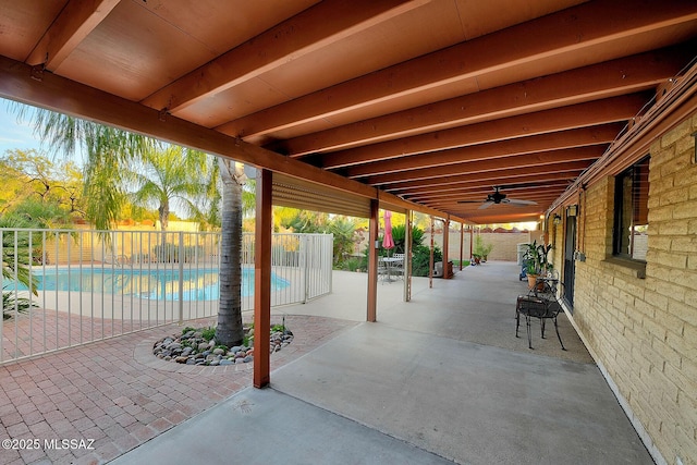 view of patio / terrace featuring a fenced in pool and ceiling fan