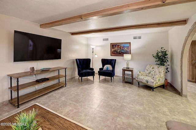 sitting room featuring beam ceiling