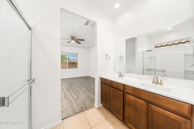 bathroom with tile patterned floors, ceiling fan, an enclosed shower, and vanity