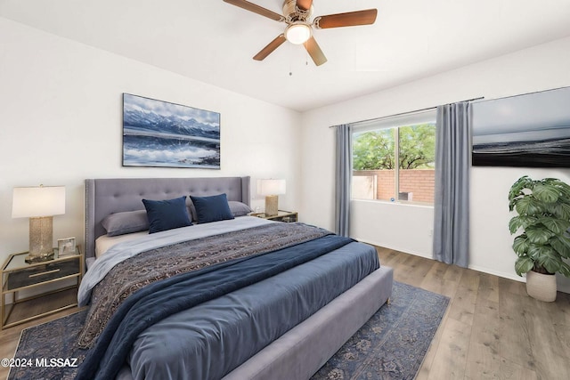 bedroom with ceiling fan and hardwood / wood-style floors