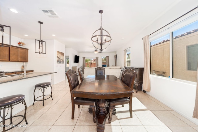 dining room featuring a notable chandelier and light tile patterned floors