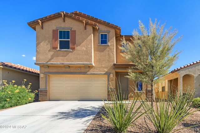 mediterranean / spanish-style home with a garage