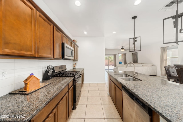 kitchen featuring ceiling fan, sink, stainless steel appliances, decorative light fixtures, and light tile patterned floors