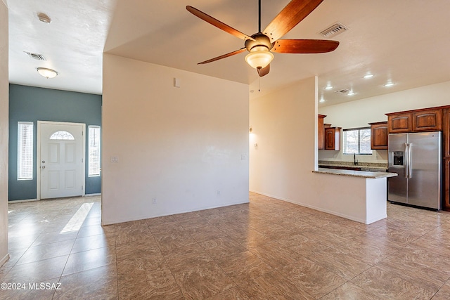 unfurnished living room with ceiling fan