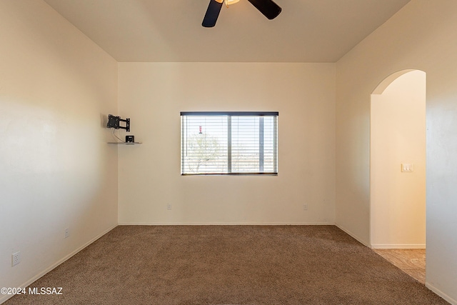 empty room featuring carpet flooring and ceiling fan