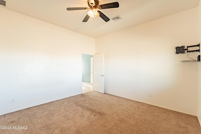 empty room with ceiling fan and light colored carpet