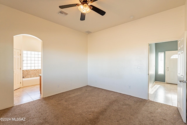 empty room featuring light carpet and ceiling fan