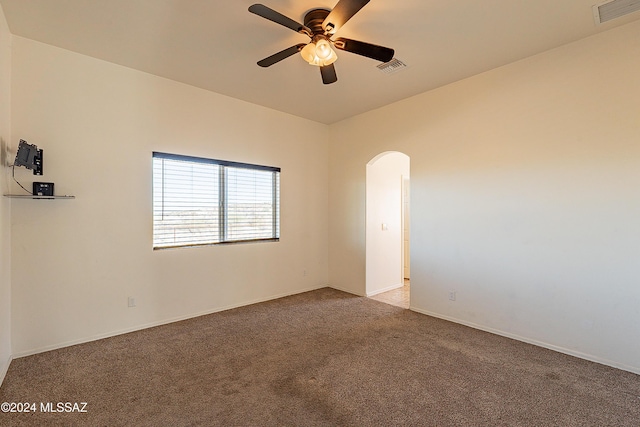 carpeted spare room with ceiling fan