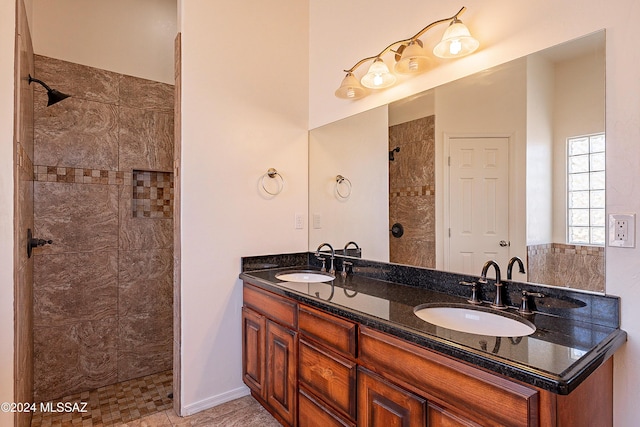 bathroom with tiled shower and vanity