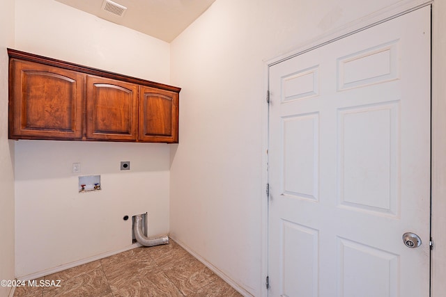 laundry room featuring electric dryer hookup, cabinets, and washer hookup