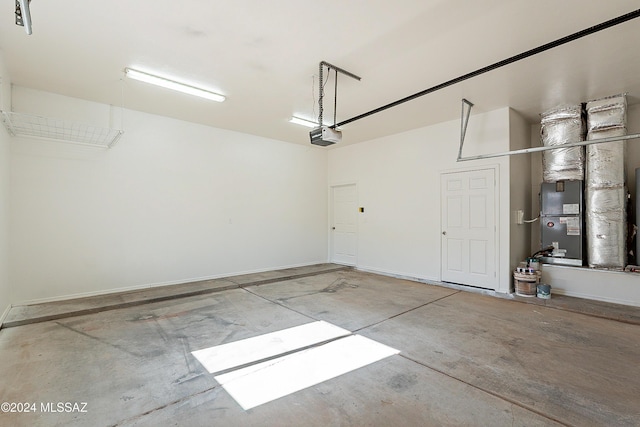 garage featuring a garage door opener and heating unit