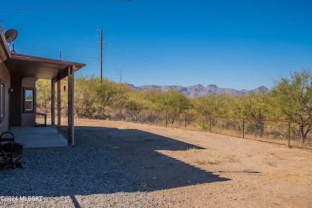 view of yard featuring a patio area and a mountain view