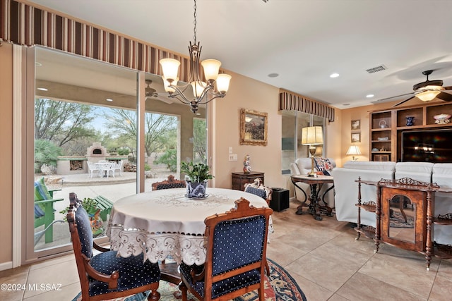 dining space featuring light tile patterned floors and ceiling fan with notable chandelier