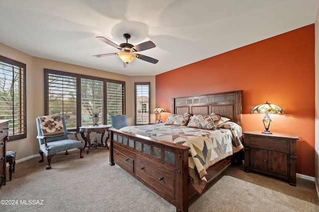 bedroom with light carpet and ceiling fan