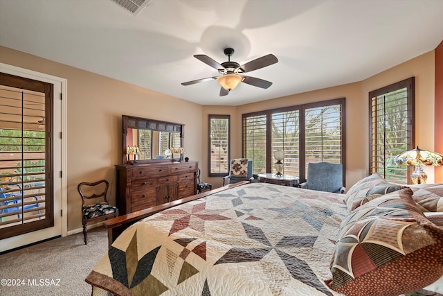 carpeted bedroom with ceiling fan and access to outside